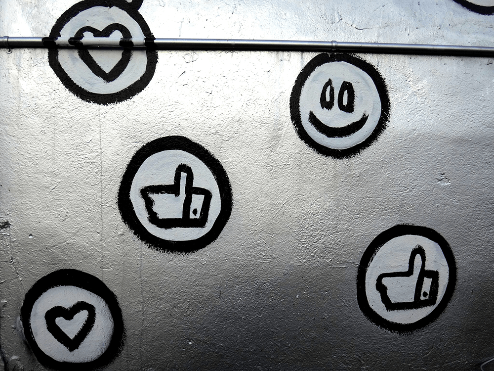 A wall with emoji graffiti